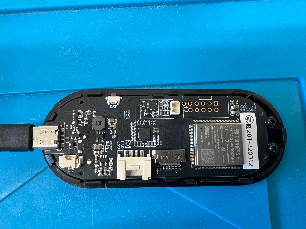 The T-Embed with its rear cover removed, showing the ESP32-S3 module and connectors